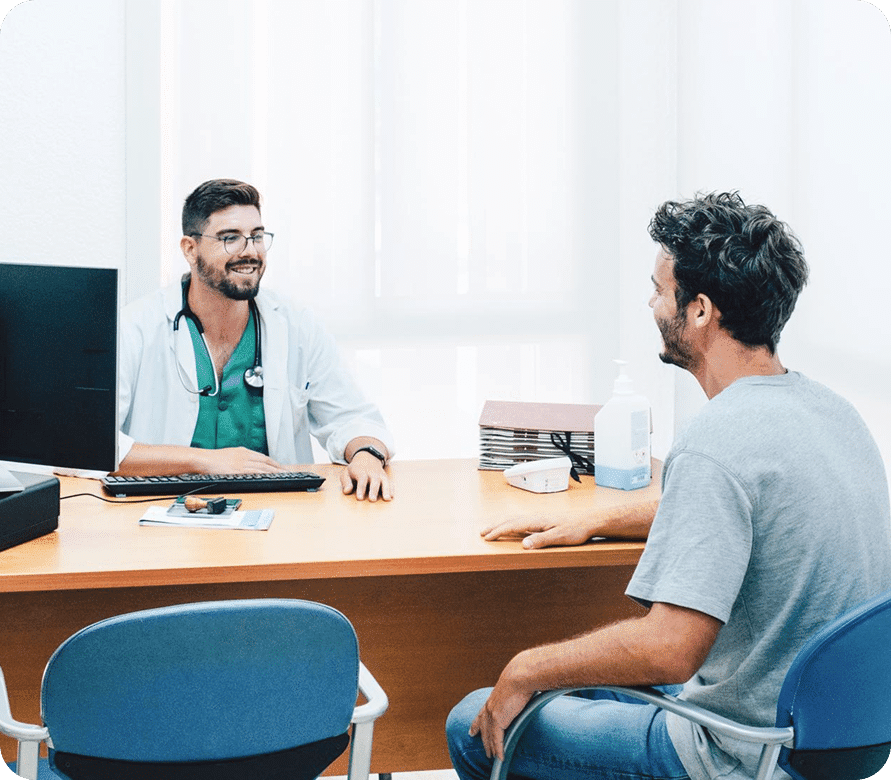 Doctor consulting with a male patient in a clinic, representing medical advice, diagnosis discussion, and support for Bowel Cancer screening and treatment.