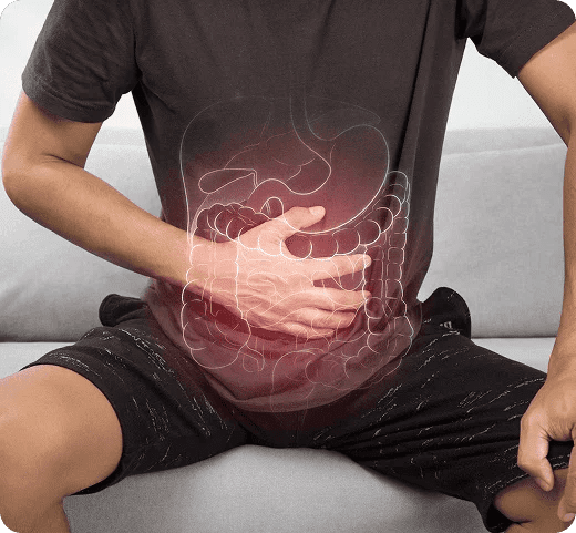 Person holding their abdomen with a digestive system illustration overlay, highlighting stomach and intestinal pain related to Bowel Cancer symptoms and gastroenterology care.